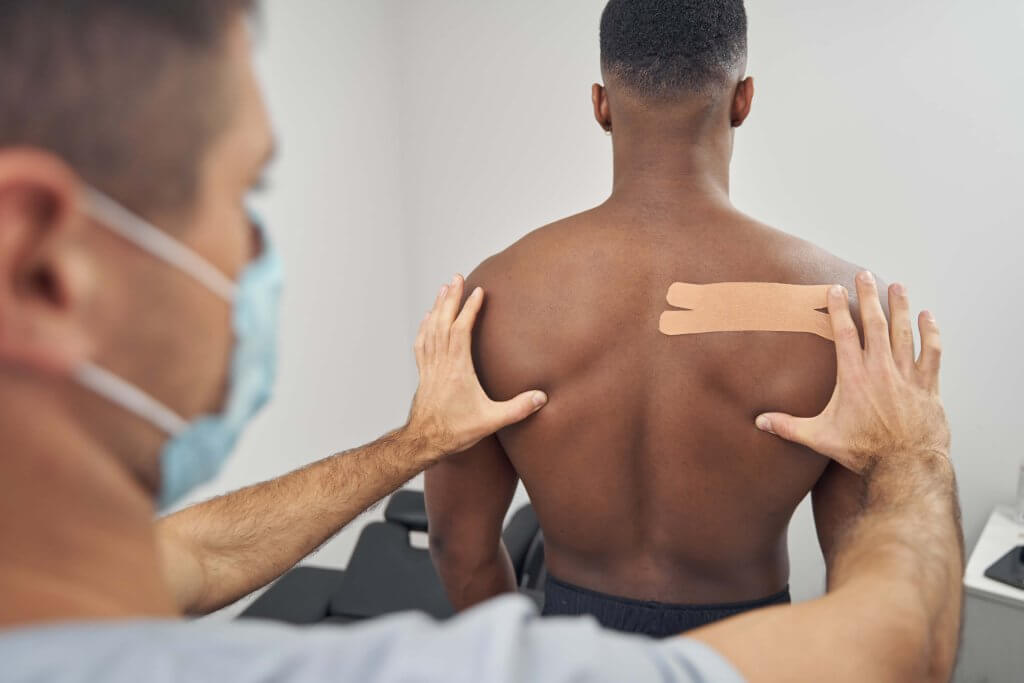 Doctor Using Kinesiology Taping Technique During P 2022 01 04 22 07 59 Utc 1
