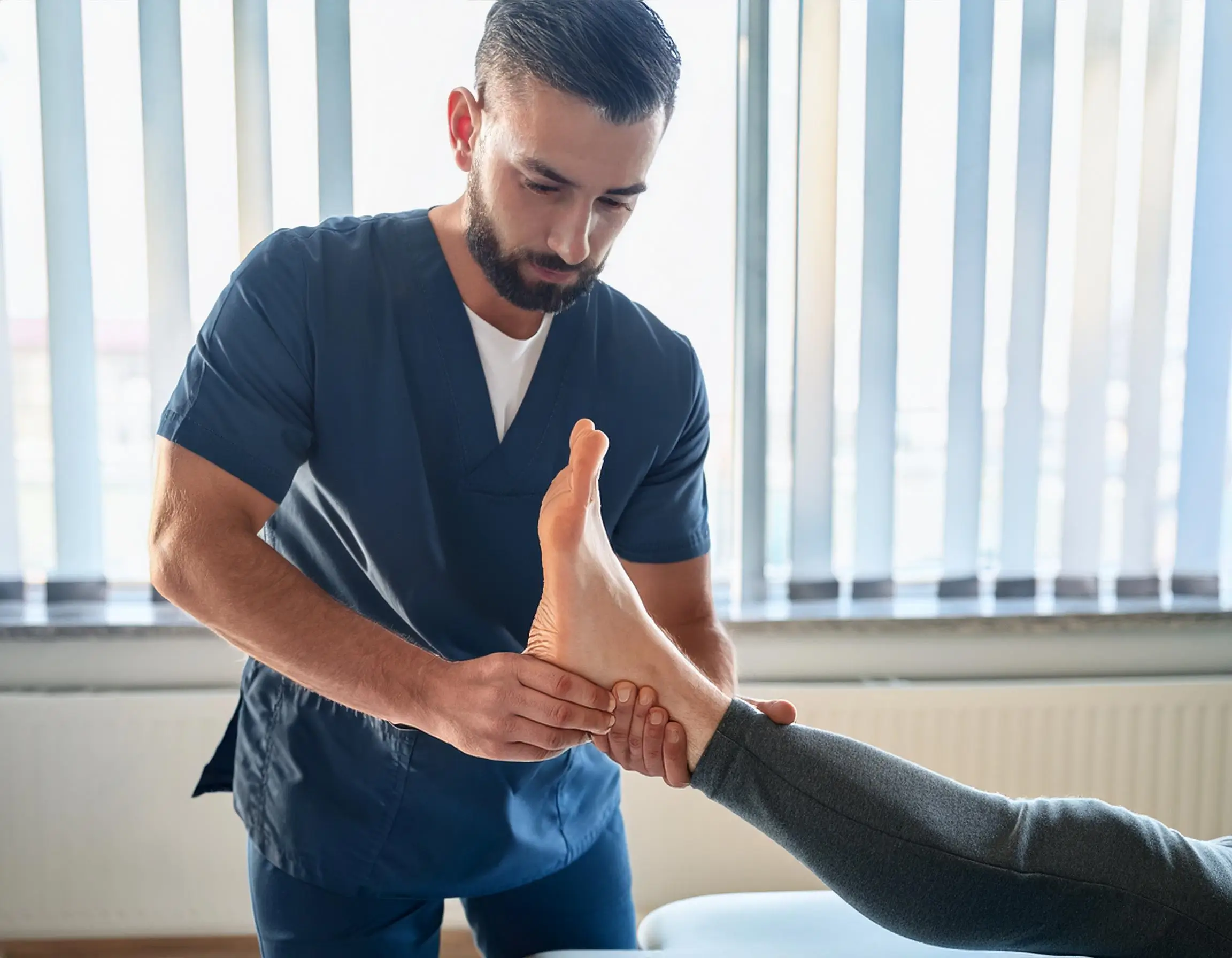 Firefly A Physiotherapist Performing Manual Therapy On A Patient S Foot To Treat Plantar Fasciitis I